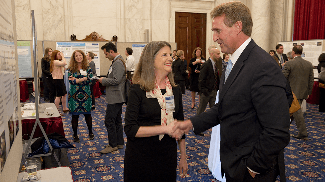 Kim Phillips, PhD, Trinity University, meets with Sen. Jeff Flake (R-Ariz.) at a Capitol Hill exhibit defending unjustly targeted research